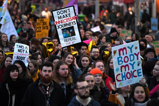 Demonstrators hold posters as they march for more liberal Irish abortion laws, in Dublin 