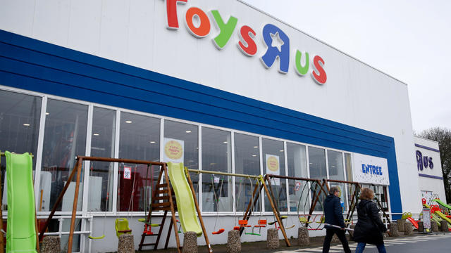 Customers walk in front of the Toys R Us store at Saint-Sebastien-sur-Loire near Nantes 
