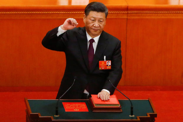 Chinese President Xi Jinping pledges an oath to the Constitution after being confirmed president for another term during the National People's Congress at the Great Hall of the People in Beijing 