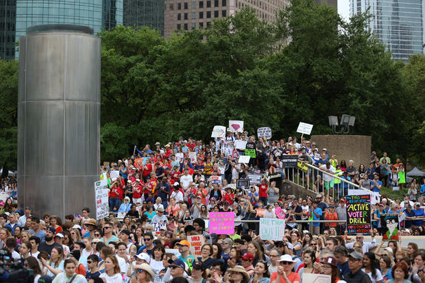 People gather to walk with the "March for Our Lives", an organized demonstration to end gun violence, in downtown Houston 