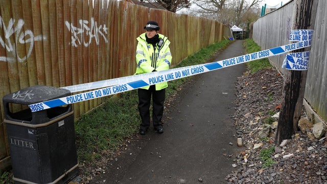 A police officer stands behind cordon tape in an alleyway which has been blocked off near the home of former Russian intelligence officer Sergei Skripal in Salisbury 