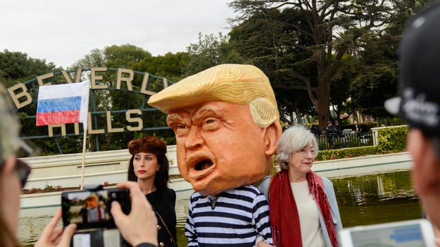 People protest at a park a few miles from a gated community where U.S. President Donald Trump is holding a fundraiser in Beverly Hills 