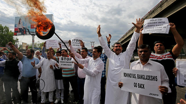 Activists of National Panther party burn tyres and shout slogans during a protest in support of various demands, in Jammu 