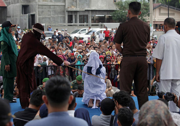 An Indonesian woman is publicly caned for prostitution in Banda Aceh 