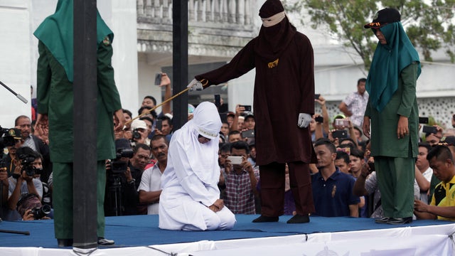 An Indonesian woman is publicly caned for prostitution in Banda Aceh 