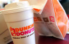 A cup of Dunkin' Donuts coffee and a doughnut bag sit on a counter Sept. 7, 2006, in Chicago, Illinois. 