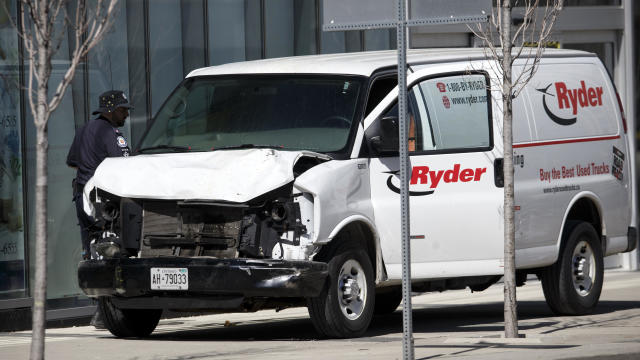 Police inspect a van suspected of being involved in a collision at Yonge Street and Finch Avenue on April 23, 2018, in Toronto, Canada. 