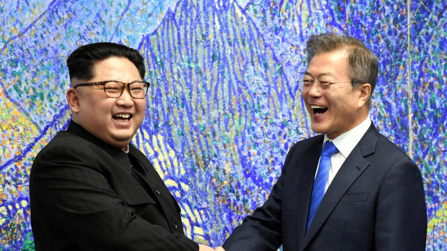 South Korean President Moon Jae-in shakes hands with North Korean leader Kim Jong Un during their meeting at the Peace House 