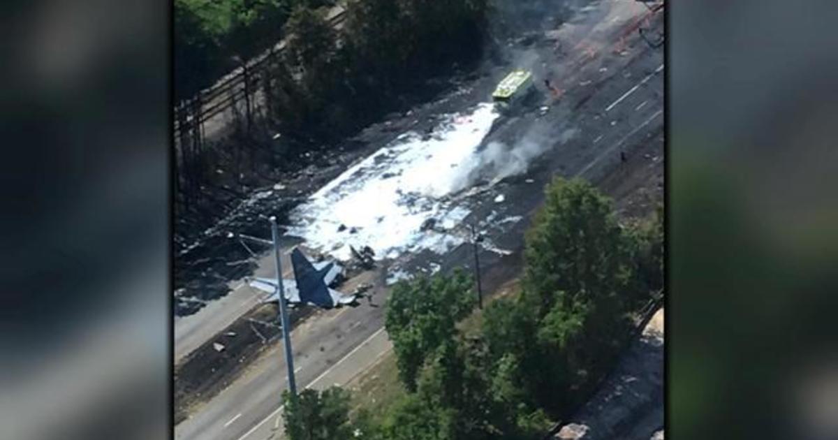 Military plane crashes in explodes into flames on highway