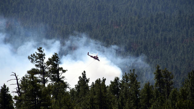 A helicopter fights a wildfire in north-central Arizona April 30, 2018, in this photo provided by the U.S. Forest Service. 