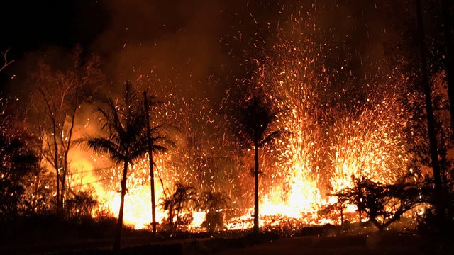 Handout photo of a new fissure spraying lava fountains as high as about 230 feet (70 m), according to United States Geological Survey, is shown from Luana Street in Leilani Estates subdivision on Kilauea Volcano's lower East Rift Zone in Hawaii 
