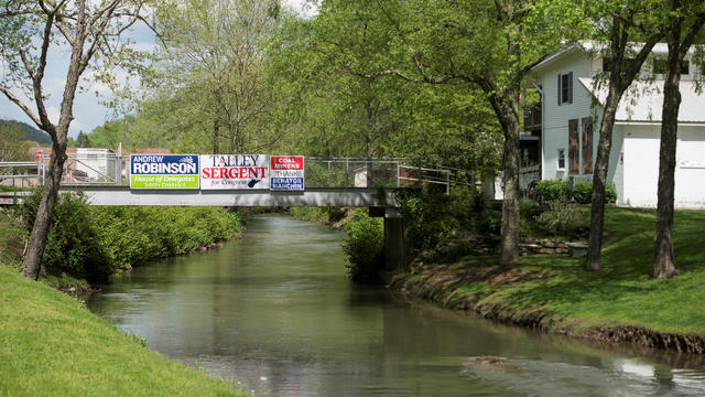 State and local campaign signs are hung along a residential bridge outside of Charleston, West Virginia 