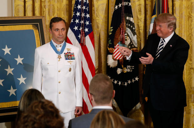 U.S. President Donald Trump gestures after awarding the Medal of Honor to Retired Navy Master Chief Special Warfare Operator Britt Slabinski for “conspicuous gallantry” in the East Room of the White House in Washington 