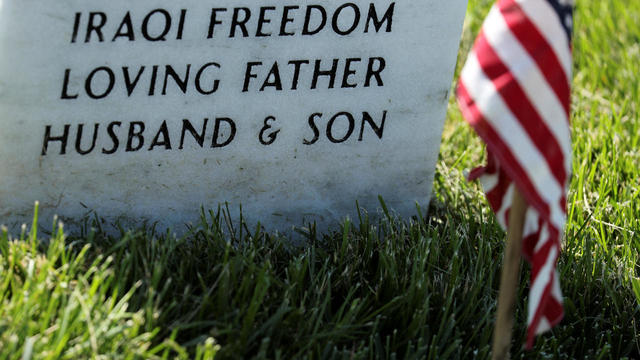 U.S. Army soldiers of the 3rd United States Infantry Regiment arrive to place U.S. flags on graves at Arlington National Cemetery 