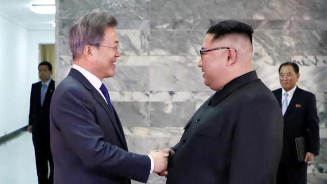 South Korean President Moon Jae-in shakes hands with North Korean leader Kim Jong Un during their summit at the truce village of Panmunjom 