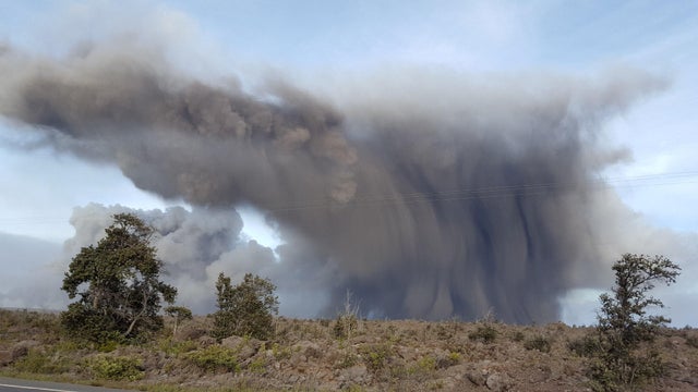 Ash eruption from the Kilauea Volcano rises above the landscape near Pahoa, Hawaii in this May 24, 2018 handout photo 