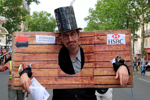 A protester dressed as a banker attends a demonstration by French unions and France Insoumise" (France Unbowed) political party to protest against government reforms, in Paris 