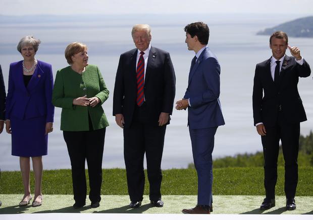 Leaders wave after posing for family photo at the G7 Summit in La Malbaie 