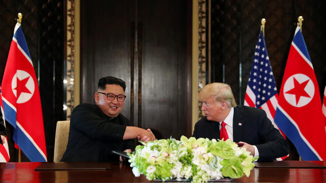 Donald Trump, Kim Jong Un signing U.S.-North Korea summit 