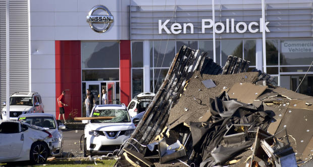 Debris and damaged vehicles sit in front of a car dealership on June 14, 2018, in Wilkes-Barre Township, Pennsylvania. 
