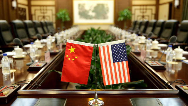 FILE PHOTO: Flags of U.S. and China are placed for a meeting in Beijing 