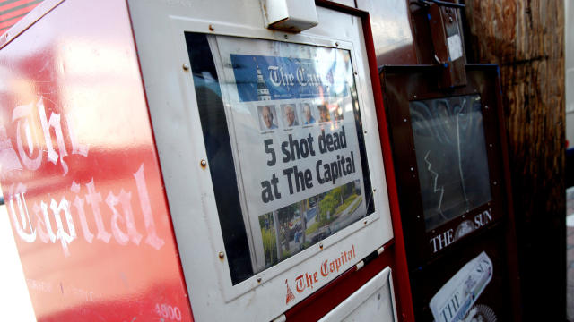 A copy of the Capital Gazette is displayed in a newspaper box the day after a gunman killed five people and injured several others at the publication's offices in Annapolis, Maryland, June 29, 2018. 