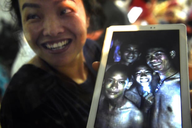 A happy family member shows members of a boys soccer team found by rescue divers inside Tham Luang cave after the team and their coach went missing for over a week at Khun Nam Nang Non Forest Park in Chiang Rai, Thailand, July 2, 2018. 