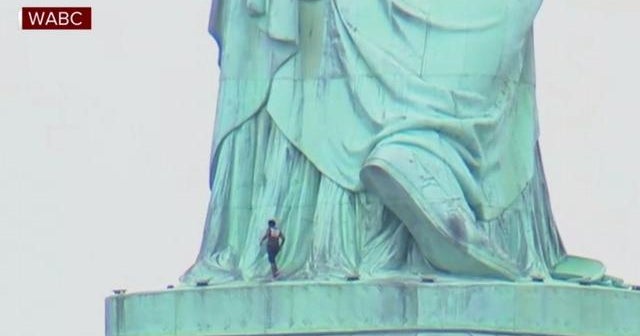 Woman climbing on Statue of Liberty prompts evacuation CBS News