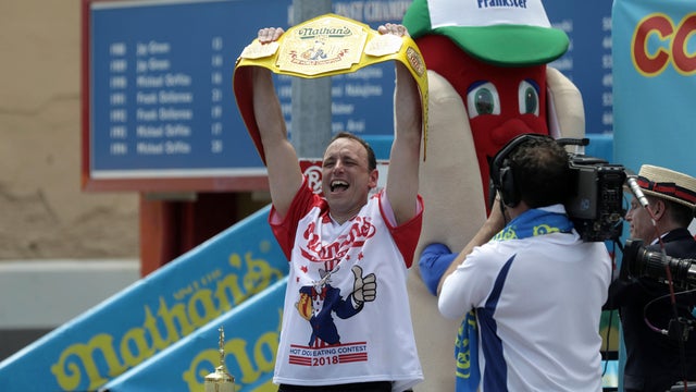 A man covers his ears from noise as people attend the annual Nathan's Famous hot dog eating contest on July 4, 2018, in the Coney Island neighborhood of the Brooklyn borough of New York City. 