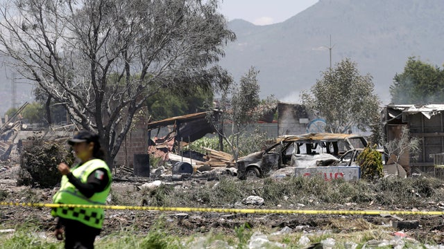 A police officer keeps watch at a site damaged due to fireworks explosions in the municipality of Tultepec 
