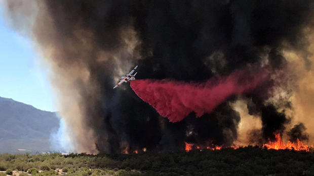 An air tanker drops retardant on the so-called Benton Fire near the intersection of Benton Road and Crams Corner Drive in this image on social media in Anza, California, on July 4, 2018. 