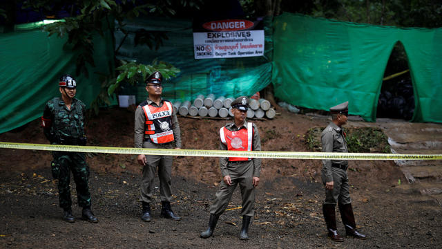 Police stand guard outside the Tham Luang cave complex after Thailand's government instructed members of the media to move out urgently, in the northern province of Chiang Rai 