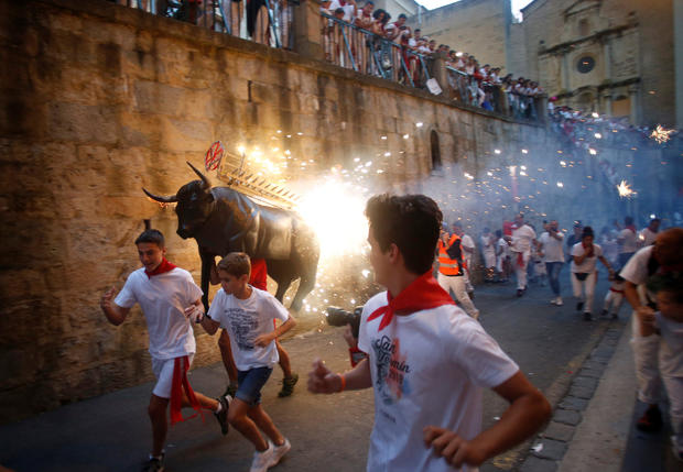 Revellers run from the Fire Bull at the San Fermin festival in Pamplona 
