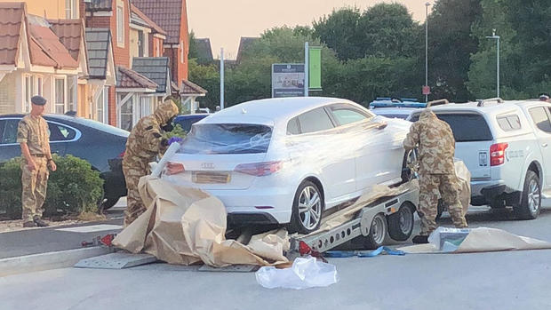 Personnel arrange the transportation of a car in relation to the ongoing nerve-agent incident in Amesbury, in Swindon 