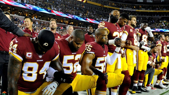 Washington Redskins tight end Niles Paul (84), linebacker Ryan Anderson (52) and linebacker Chris Carter (55) kneel with teammates during the playing of the national anthem before a game against the Oakland Raiders at FedEx Field in Landover, Maryland, on