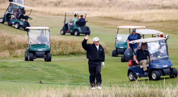 U.S. President Donald Trump gestures as he walks on the course of his golf resort, in Turnberry 