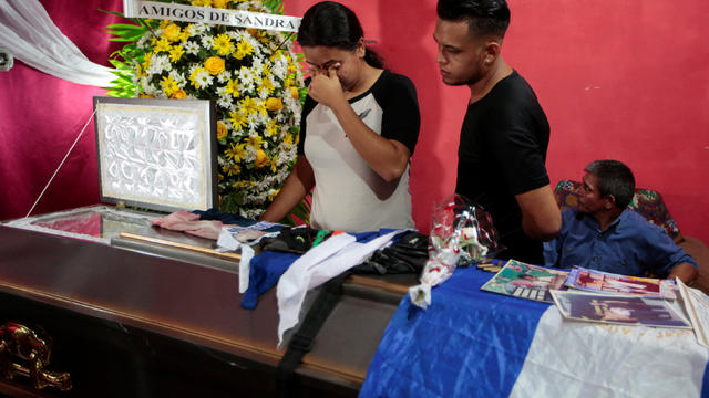 Mourners look into a coffin containing the body of Gerald Jose Vasquez,who died during clashes with riot police at the National Autonomous University of Nicaragua (UNAN), in Managua 