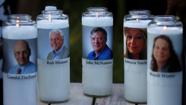 Candles representing the slain journalists of Capital Gazette sit on display during a candlelight vigil held near the Capital Gazette, the day after a gunman killed five people inside the newspaper's building in Annapolis, Maryland, U.S. 