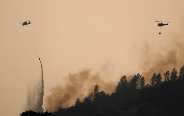 Helicopters drop water on hotspots of the Carr Fire west of Redding 