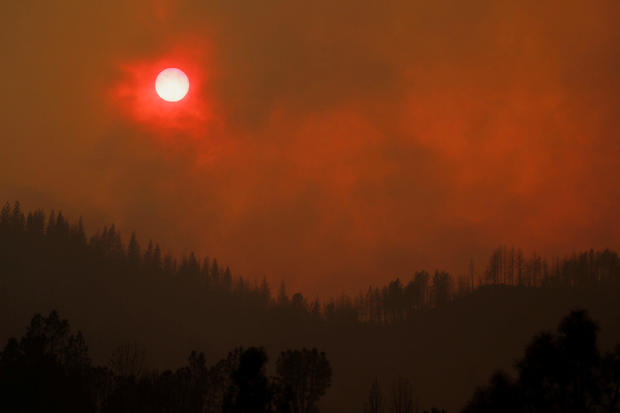 The setting sun is turned red by the smoke from the Carr Fire west of Redding 