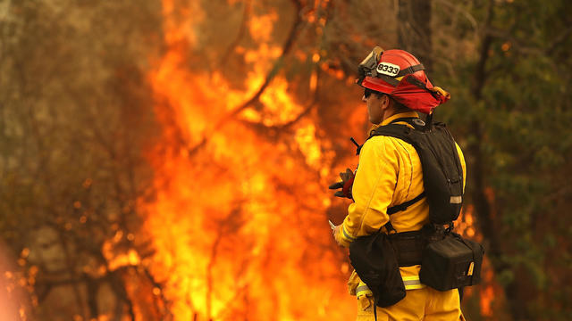 A firefighter in Redding, California, looks on as the so-called Carr Fire moves through the area on July 28, 2018. 