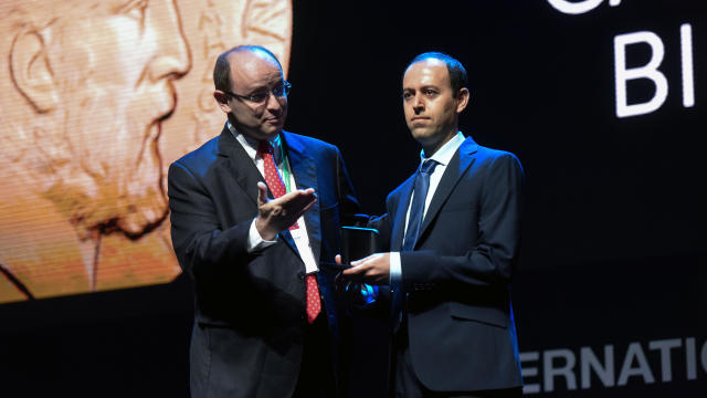 Kurdish mathematician Cauchar Birkar, right, 40, receives the Fields Medal award, math's most prestigious prize, during the International Congress of Mathematicians in Rio de Janeiro, Brazil, on Aug. 1, 2018. 