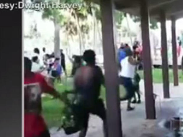 In this still from video posted on social media, people race for cover as a gunman opens fire Aug. 4, 2018, at a peace rally in Titusville, Florida. 