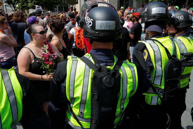 Police in riot gear block demonstrators at the site where Heather Heyer was killed in Charlottesville 
