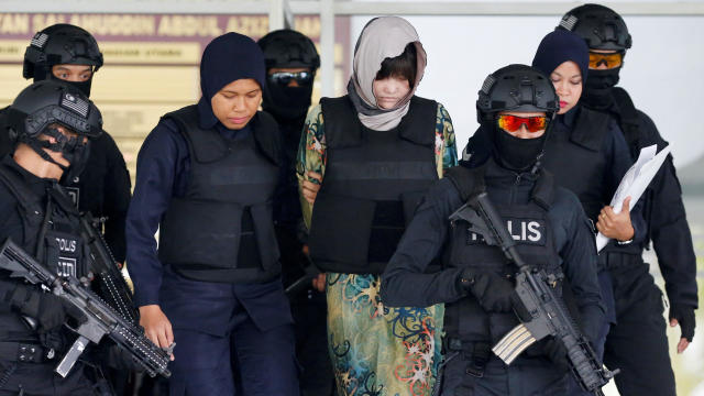 Vietnamese Doan Thi Huong is escorted as she leaves the Shah Alam High Court 