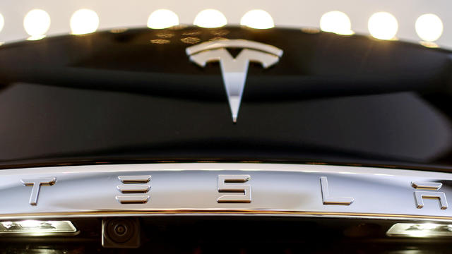 FILE PHOTO: A Tesla logo adorns a 'Model S' car in the dealership in Berlin 