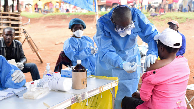 FILE PHOTO: A Congolese health worker administers Ebola vaccine to a woman who had contact with an Ebola sufferer in the village of Mangina 