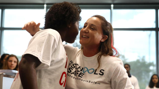 Lori Alhadeff, right, whose daughter Alyssa Alhadeff was among the 17 people killed in the Feb. 14, 2018, shooting at Marjory Stoneman Douglas High School, hugs Melia Rodriguez as she joins with students from the advisory board of the 17 For Change initiative at a news conference at Coral Springs City Hall on March 28, 2018, in Coral Springs, Florida. 