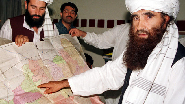 FILE PHOTO - Jalaluddin Haqqani, the Taliban's Minister for Tribal Affairs, points to a map of Afghanistan during a visit to Islamabad, Pakistan 