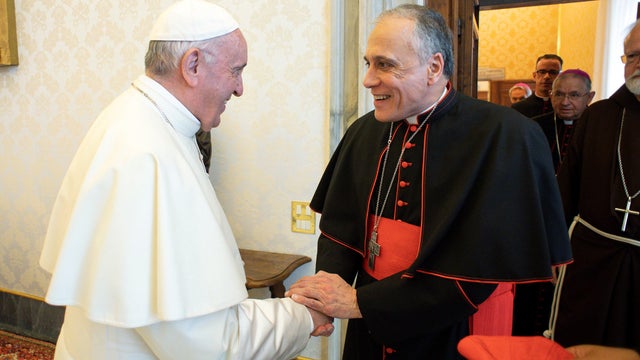 Pope Francis shakes hands with Cardinal Daniel DiNardo, Archbishop of Galveston-Houston, as he arrives with other U.S. Catholic Church leaders at the Vatican 